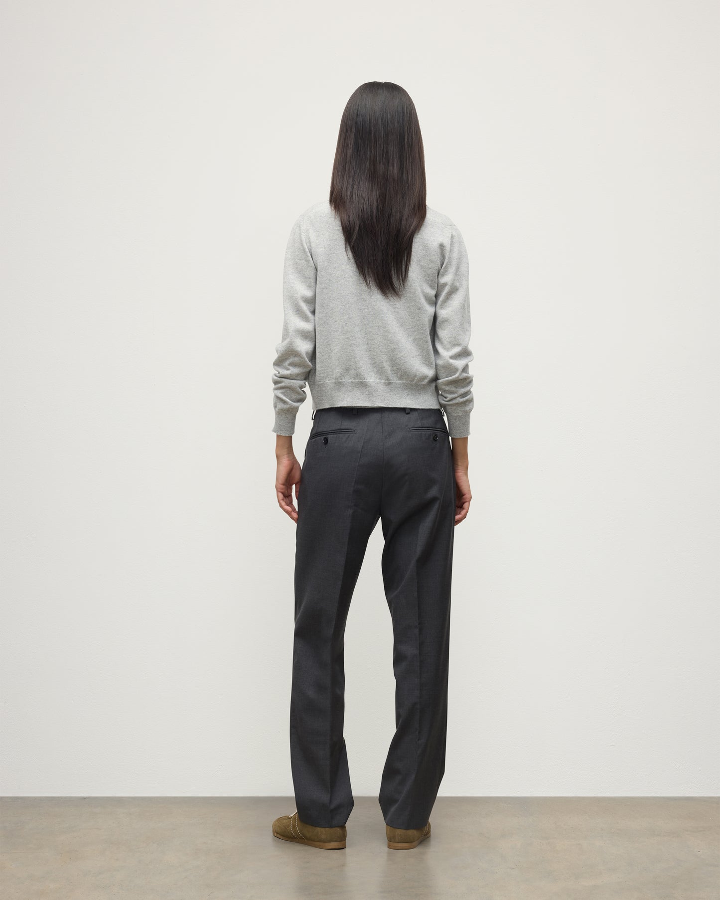 MODEL WEARS JOHNSTONS OF ELGIN WOMENS IRIS CLASSIC CREW CARDIGAN GREY WITH GREY TROUSERS AND TRAINERS  100% CASHMERE KAP05704HA0399