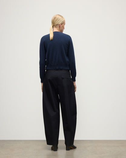 MODEL WEARING JOHNSTONS OF ELGIN WOMENS IRIS CLASSIC CREW CARDIGAN NAVY 100% CASHMERE, OVER A MATCHING SLEEVELESS TANK WITH NAVY TROUSERS, BLANK BOOTS KAP05704HD7350