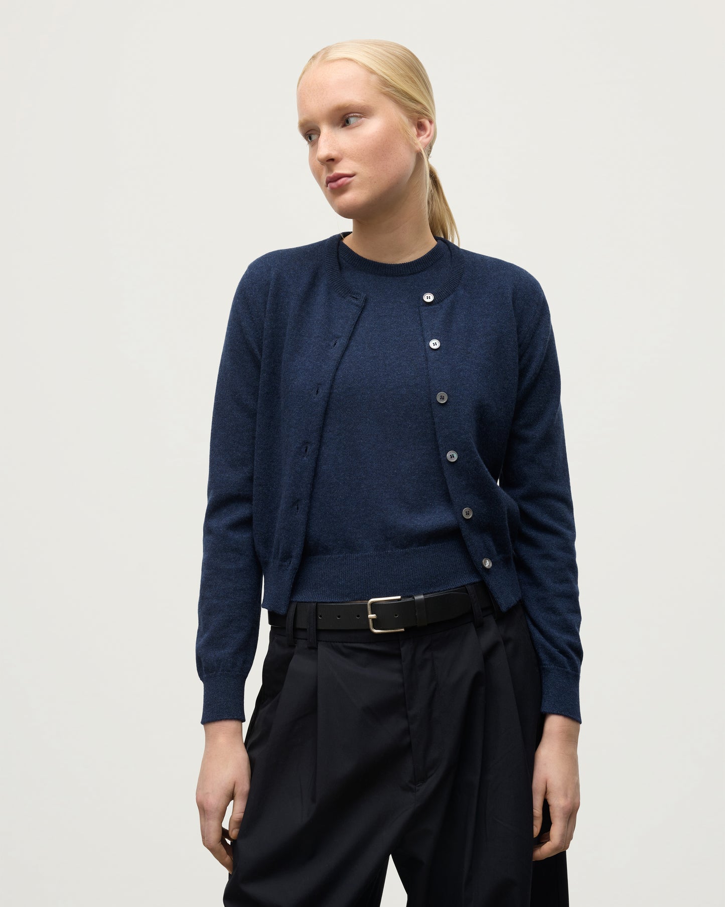 MODEL WEARING JOHNSTONS OF ELGIN WOMENS IRIS CLASSIC CREW CARDIGAN NAVY 100% CASHMERE KAP05704HD7350