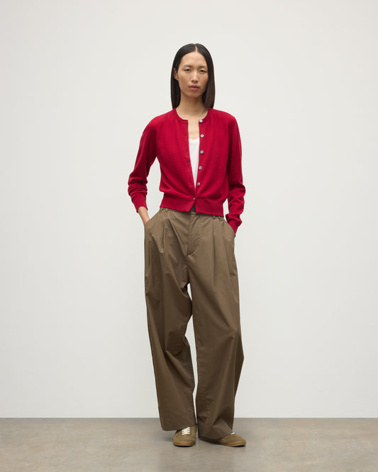 MODEL WEARS JOHNSTONS OF ELGIN WOMENS IRIS CLASSIC CREW CARDIGAN RED 100% CASHMERE OVER A WHITE VEST WITH BROWN TROUSERS AND TRAINERS  KAP05704SE5325