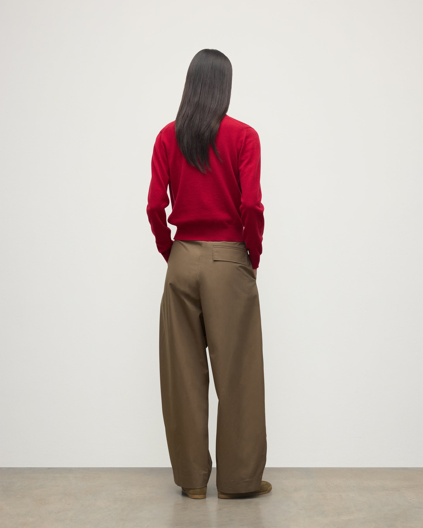 MODEL WEARS JOHNSTONS OF ELGIN WOMENS IRIS CLASSIC CREW CARDIGAN RED 100% CASHMERE OVER A WHITE VEST WITH BROWN TROUSERS AND TRAINERS  KAP05704SE5325