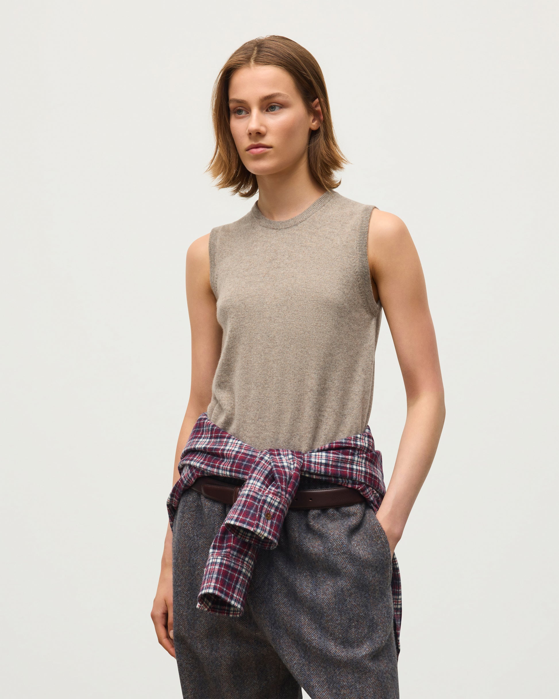 JOHNSTONS OF ELGIN IRIS SLEEVELESS CREW PETITE CASHMERE ROUND NECK TANK - 2 PLY LIGHT BROWN 100% CASHMERE WITH CLANLASS RED CHECK SHIRT TIED AROUND WAIST KAP05705HB4447