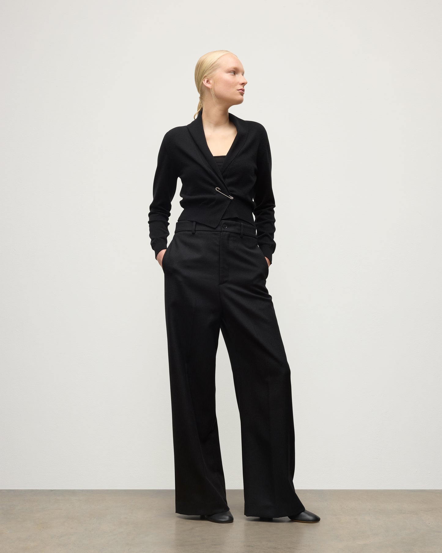 MODEL WEARS JOHNSTONS OF ELGIN WOMENS CRATHIE SHAWL CARDIGAN BLACK 100% CASHMERE WITH BLACK TROUSERS KAP05707SA7210