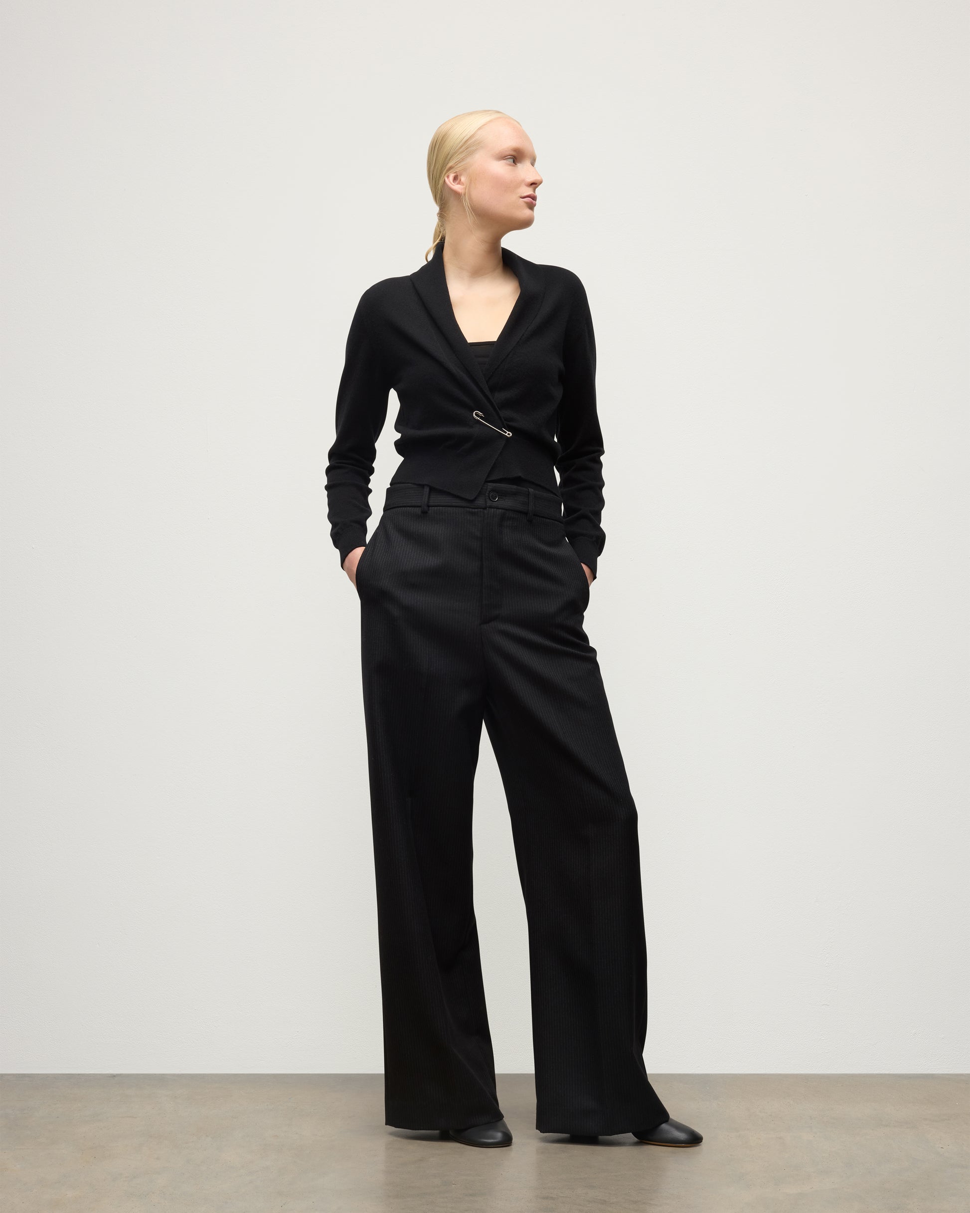 MODEL WEARS JOHNSTONS OF ELGIN WOMENS CRATHIE SHAWL CARDIGAN BLACK 100% CASHMERE WITH BLACK TROUSERS KAP05707SA7210