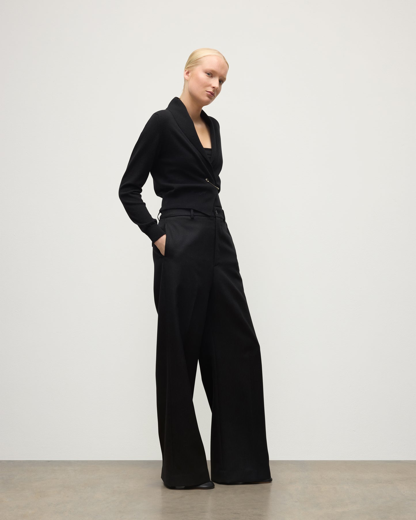 MODEL WEARS JOHNSTONS OF ELGIN WOMENS CRATHIE SHAWL CARDIGAN BLACK 100% CASHMERE WITH BLACK TROUSERS KAP05707SA7210