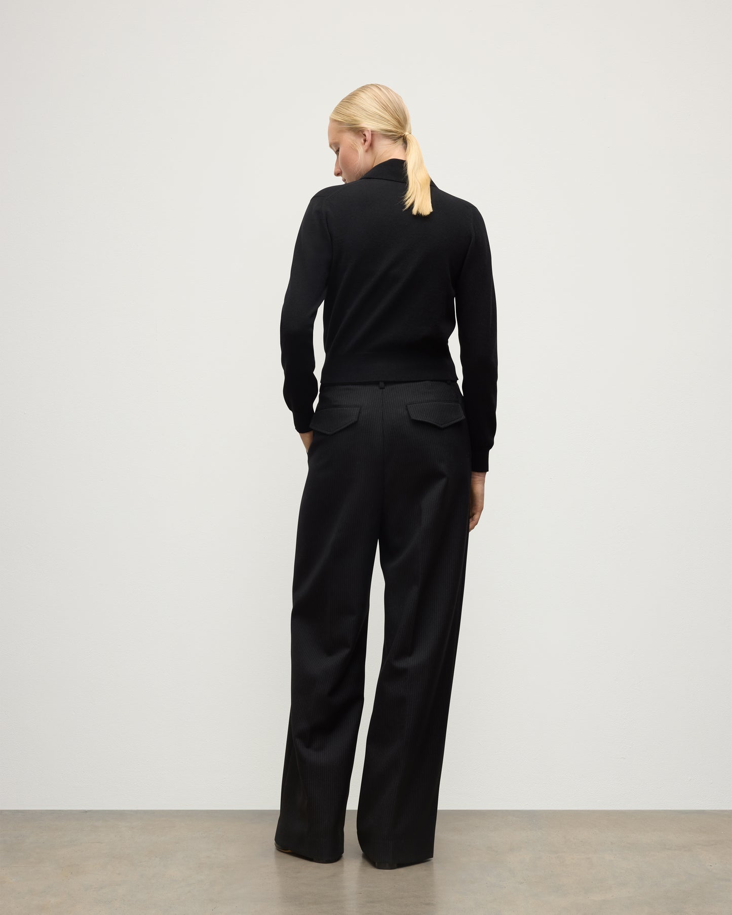 MODEL WEARS JOHNSTONS OF ELGIN WOMENS CRATHIE SHAWL CARDIGAN BLACK 100% CASHMERE WITH BLACK TROUSERS KAP05707SA7210