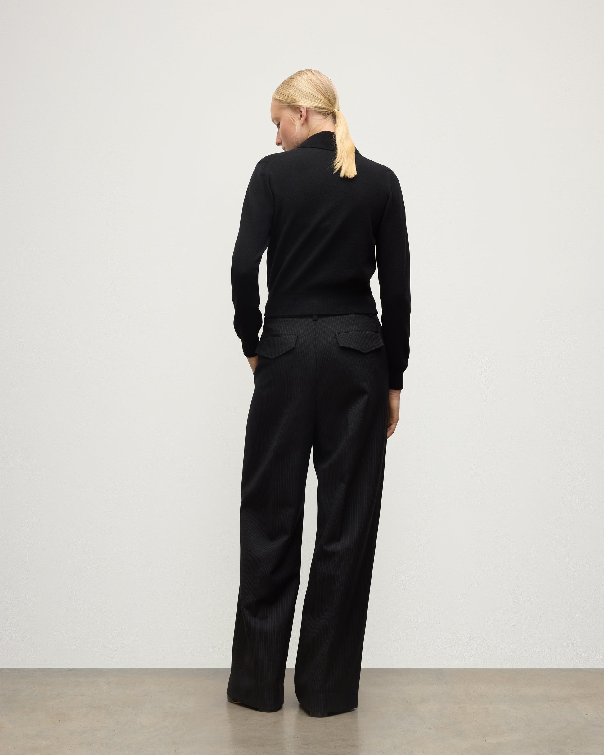 MODEL WEARS JOHNSTONS OF ELGIN WOMENS CRATHIE SHAWL CARDIGAN BLACK 100% CASHMERE WITH BLACK TROUSERS KAP05707SA7210