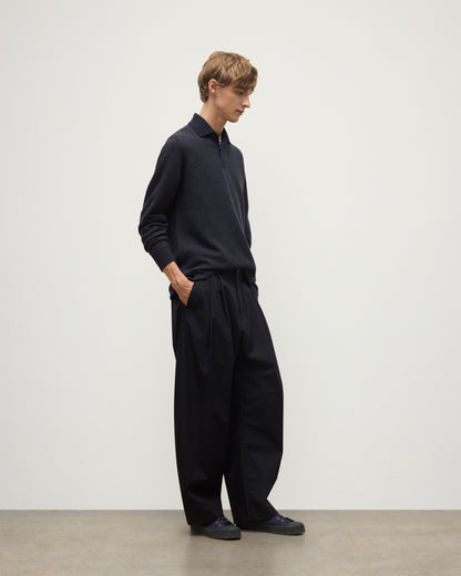 MODEL WEARS JOHNSTONS OF ELGIN MENS TWEEL RUGBY SHIRT NAVY & DARK GREY 100% CASHMERE  OVER A WHITE T-SHIRT WITH GREY TROUSERS KAP05727Q25937