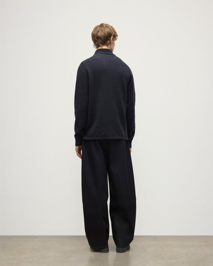 MODEL WEARS JOHNSTONS OF ELGIN MENS TWEEL RUGBY SHIRT NAVY & DARK GREY 100% CASHMERE  OVER A WHITE T-SHIRT WITH GREY TROUSERS KAP05727Q25937