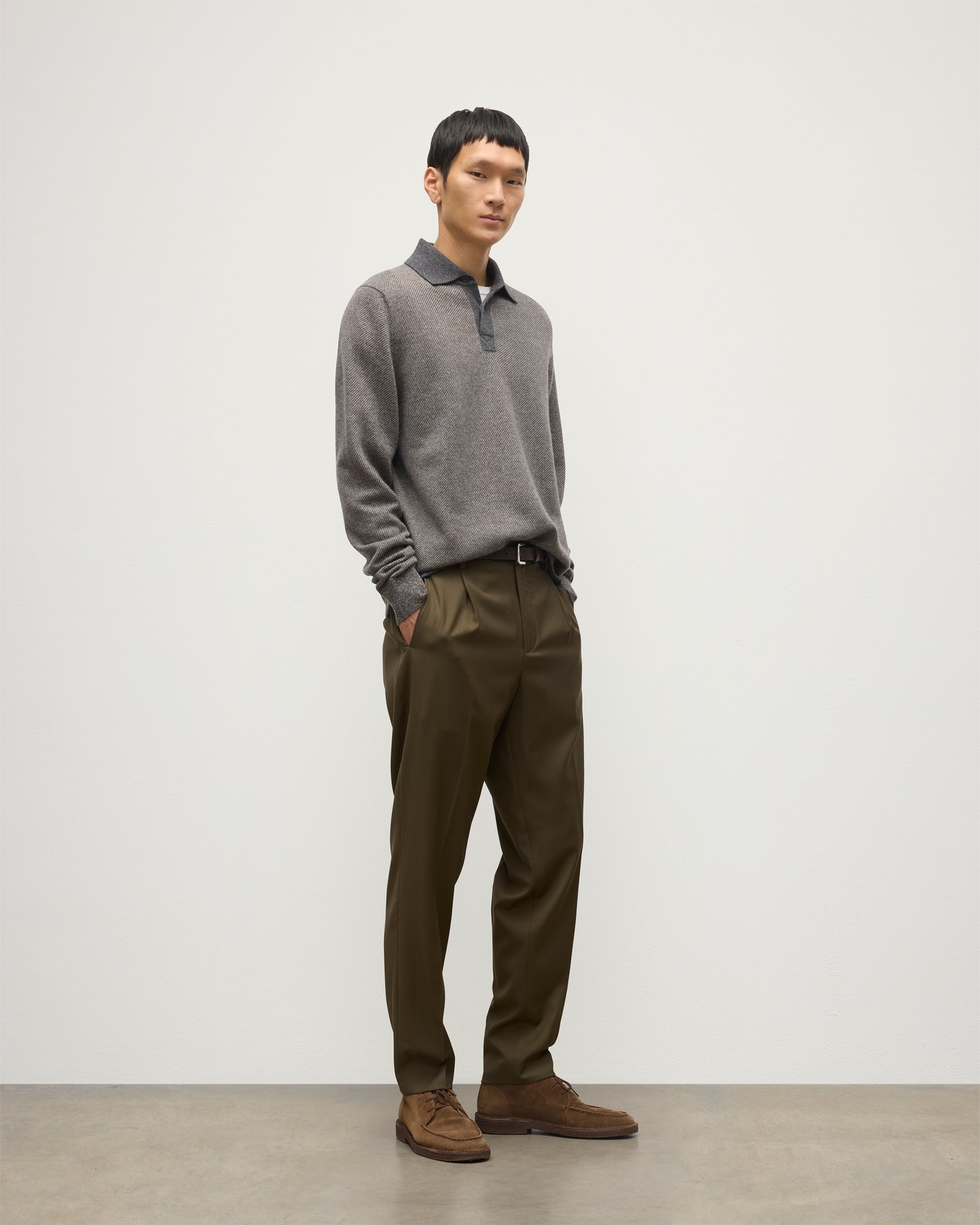 MODEL WEARS JOHNSTONS OF ELGIN MENS TWEEL RUGBY SHIRT 100% CASHMERE OVER A WHITE T-SHIRT WITH OLIVE GREEN TROUSERS KAP05727Q25939