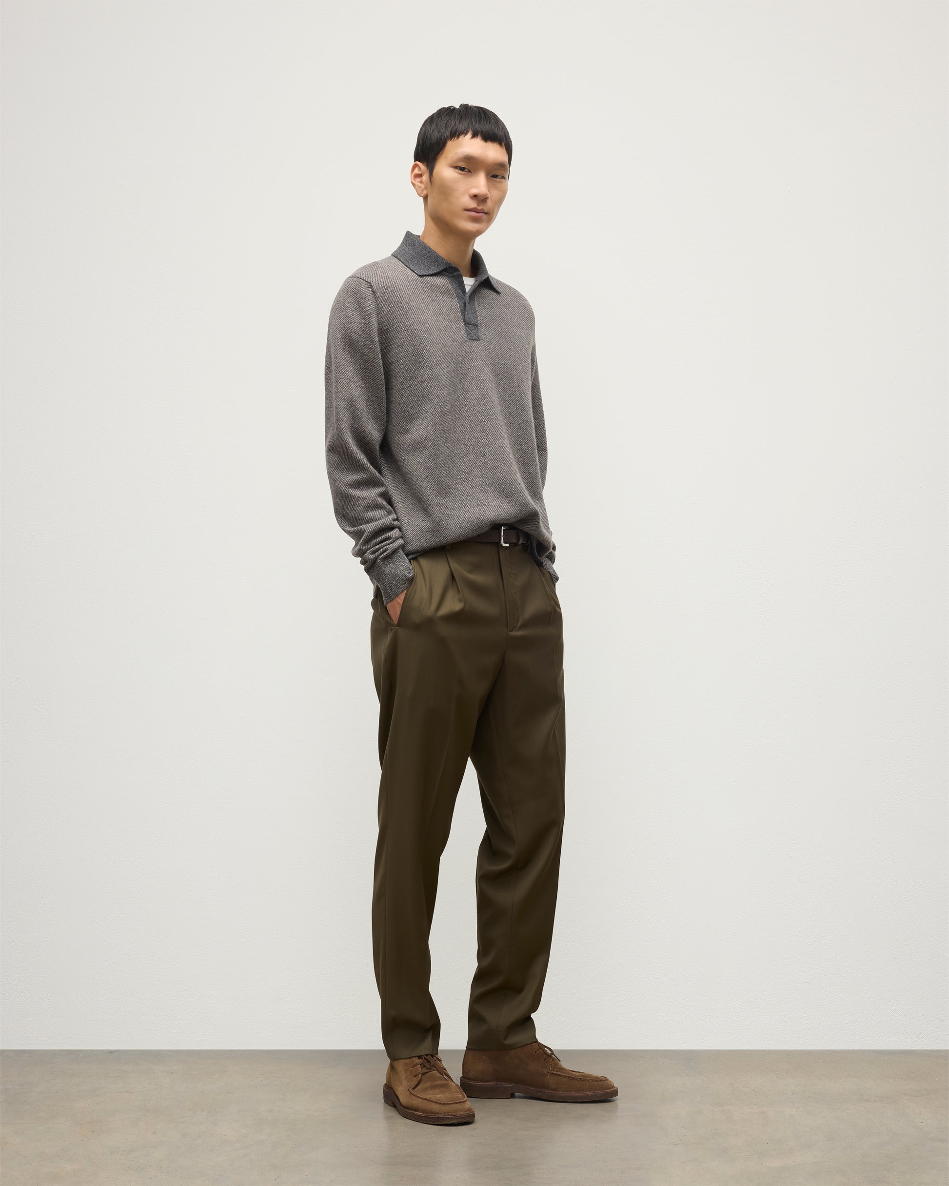 MODEL WEARS JOHNSTONS OF ELGIN MENS TWEEL RUGBY SHIRT 100% CASHMERE OVER A WHITE T-SHIRT WITH OLIVE GREEN TROUSERS KAP05727Q25939