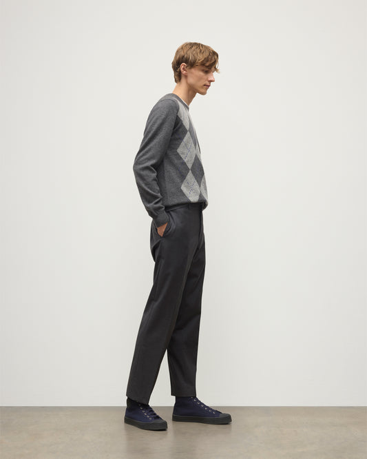 MODEL WEARS JOHNSTONS OF ELGIN MENS ARGYLL CREW SWEATER GREY & BROWN 100% CASHMERE WITH GREY TROUSERS KAP05747JU1601