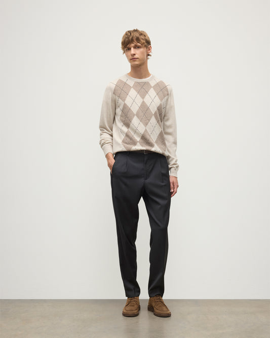MODEL WEARS JOHNSTONS OF ELGIN MENS ARGYLL CREW SWEATER NATURAL 100% CASHMERE WITH NAVY TROUSERS KAP05747JU1602