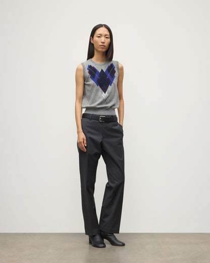 MODEL WEARS JOHNSTONS OF ELGIN WOMENS ARGYLL LE JABOTS SLEEVELESS CREW GREY 100% CASHMERE WITH BELTED GREY TROUSERS AND BLACK BOOTS KAP05766JU1611