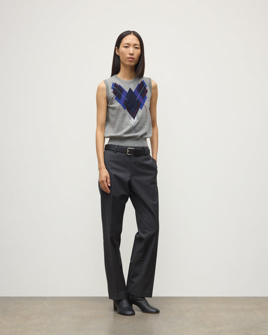 MODEL WEARS JOHNSTONS OF ELGIN WOMENS ARGYLL LE JABOTS SLEEVELESS CREW GREY 100% CASHMERE WITH BELTED GREY TROUSERS AND BLACK BOOTS KAP05766JU1611