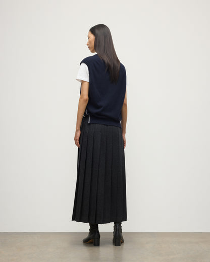 MODEL WEARS JOHYNSTONS OF ELGIN WOMENS TILDA SLEEVELESS VEE NAVY 100% CASHMERE WITH LE KILT JOHNSTONS OF ELGIN CASHMERE KILT IN CHARCOAL KAP05767Q25968