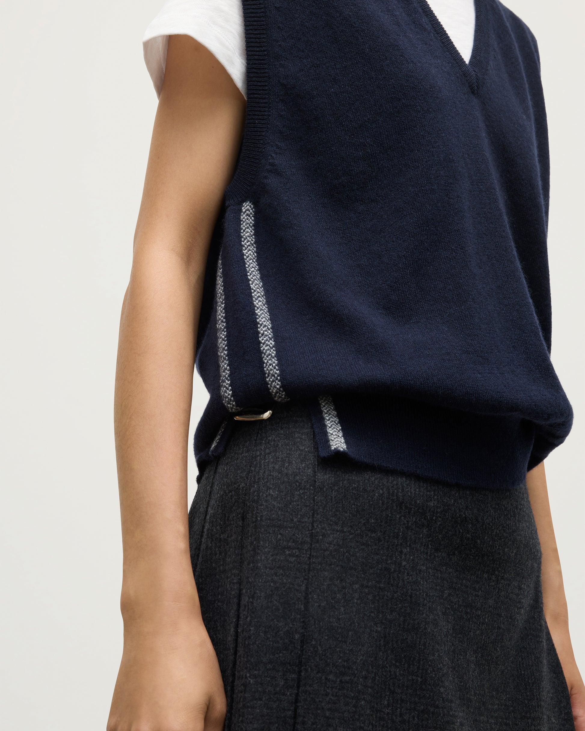 MODEL WEARS JOHYNSTONS OF ELGIN WOMENS TILDA SLEEVELESS VEE NAVY 100% CASHMERE OVER A WHITE TEE KAP05767Q25968