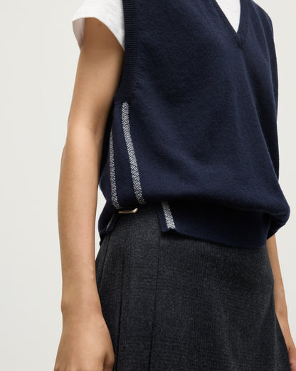 MODEL WEARS JOHYNSTONS OF ELGIN WOMENS TILDA SLEEVELESS VEE NAVY 100% CASHMERE OVER A WHITE TEE KAP05767Q25968