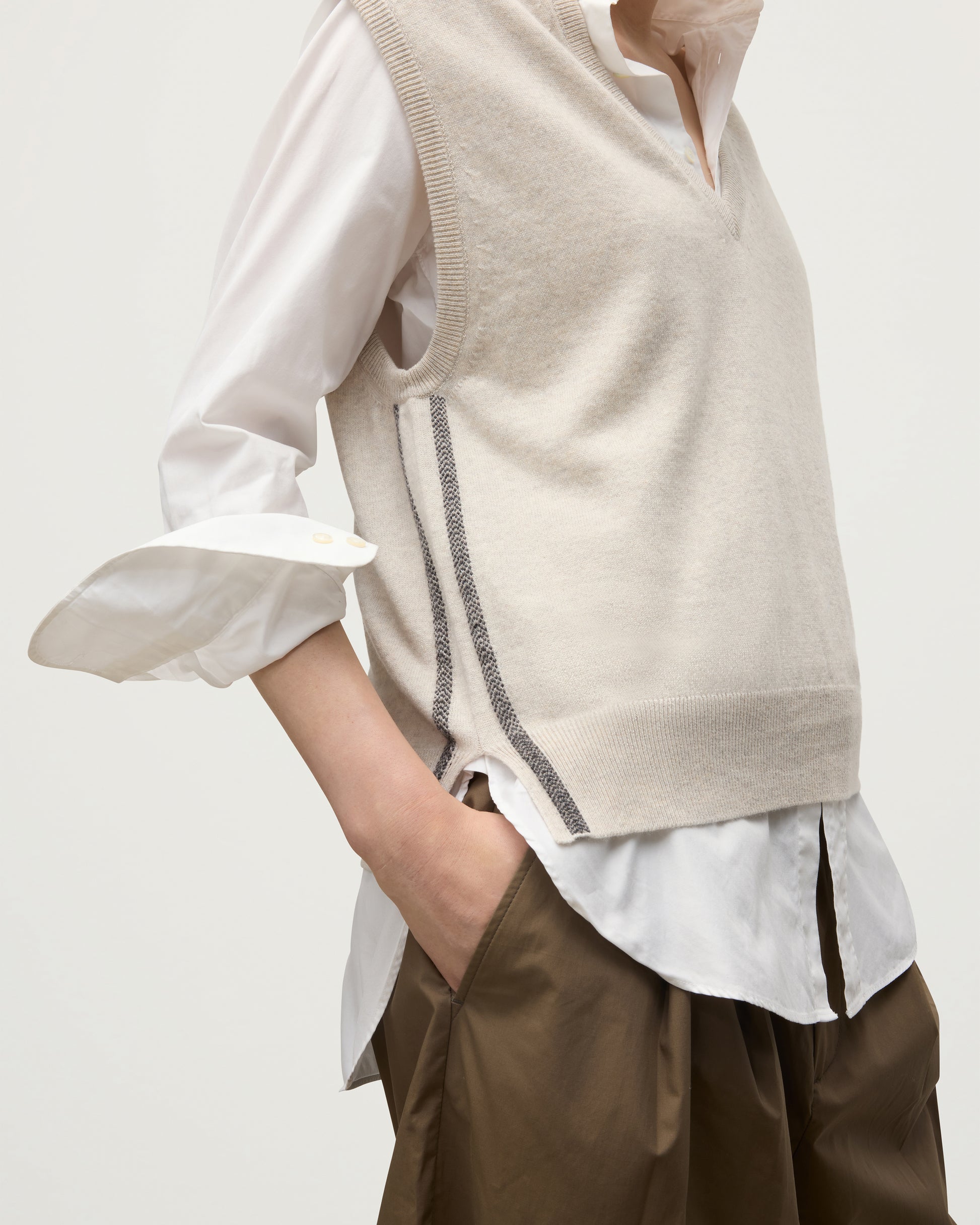 MODEL WEARS JOHNSTONS OF ELGIN WOMENS TILDA SLEEVELESS VEE NATURAL 100% CASHMERE OVER A WHITE SHIRT KAP05767Q25969