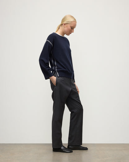 MODEL WEARING JOHNSTONS OF ELGIN WOMENS TILDA CREW SWEATER NAVY WITH GREY TROUSERS KAP05768Q25971