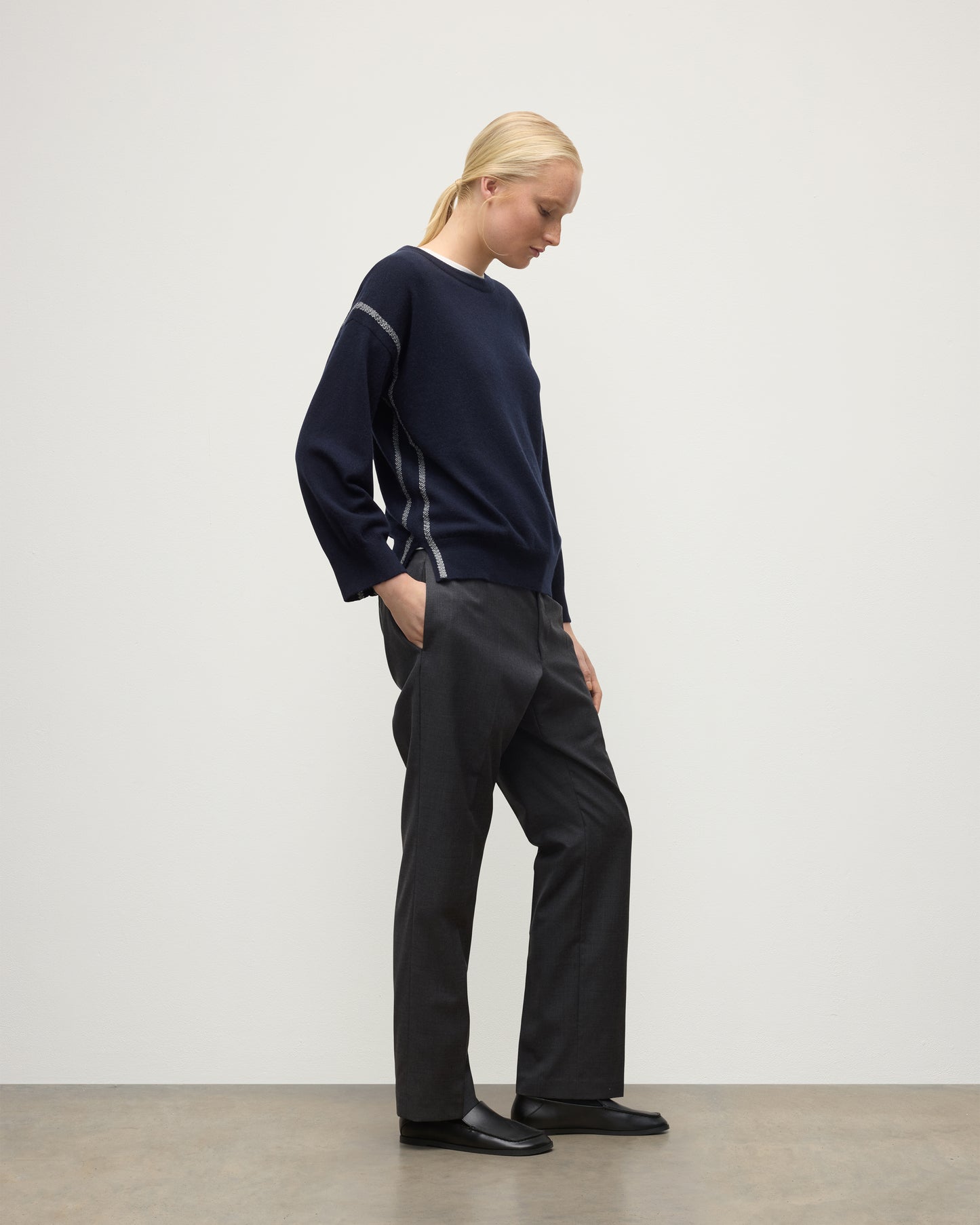 MODEL WEARING JOHNSTONS OF ELGIN WOMENS TILDA CREW SWEATER NAVY WITH GREY TROUSERS KAP05768Q25971