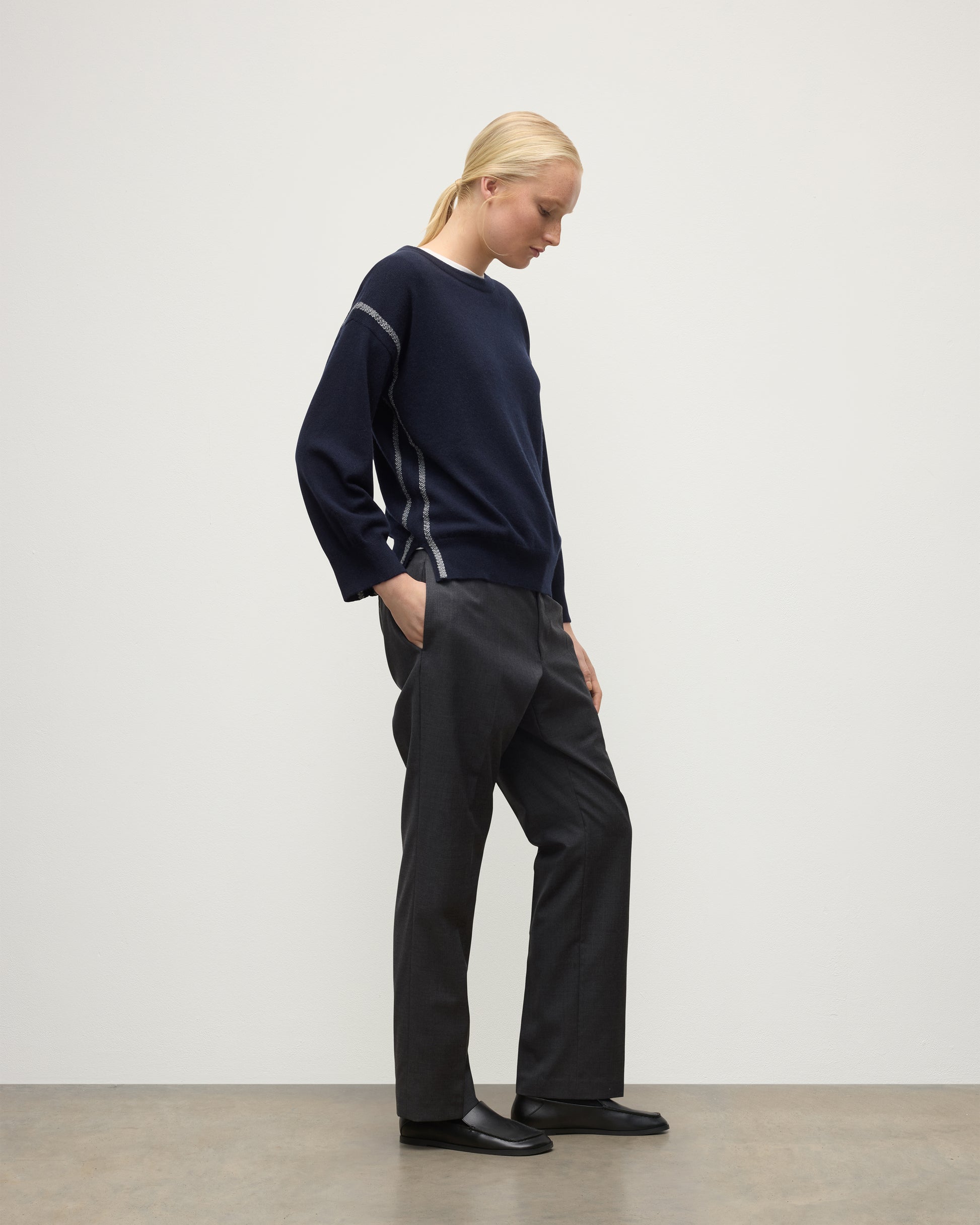 MODEL WEARING JOHNSTONS OF ELGIN WOMENS TILDA CREW SWEATER NAVY WITH GREY TROUSERS KAP05768Q25971