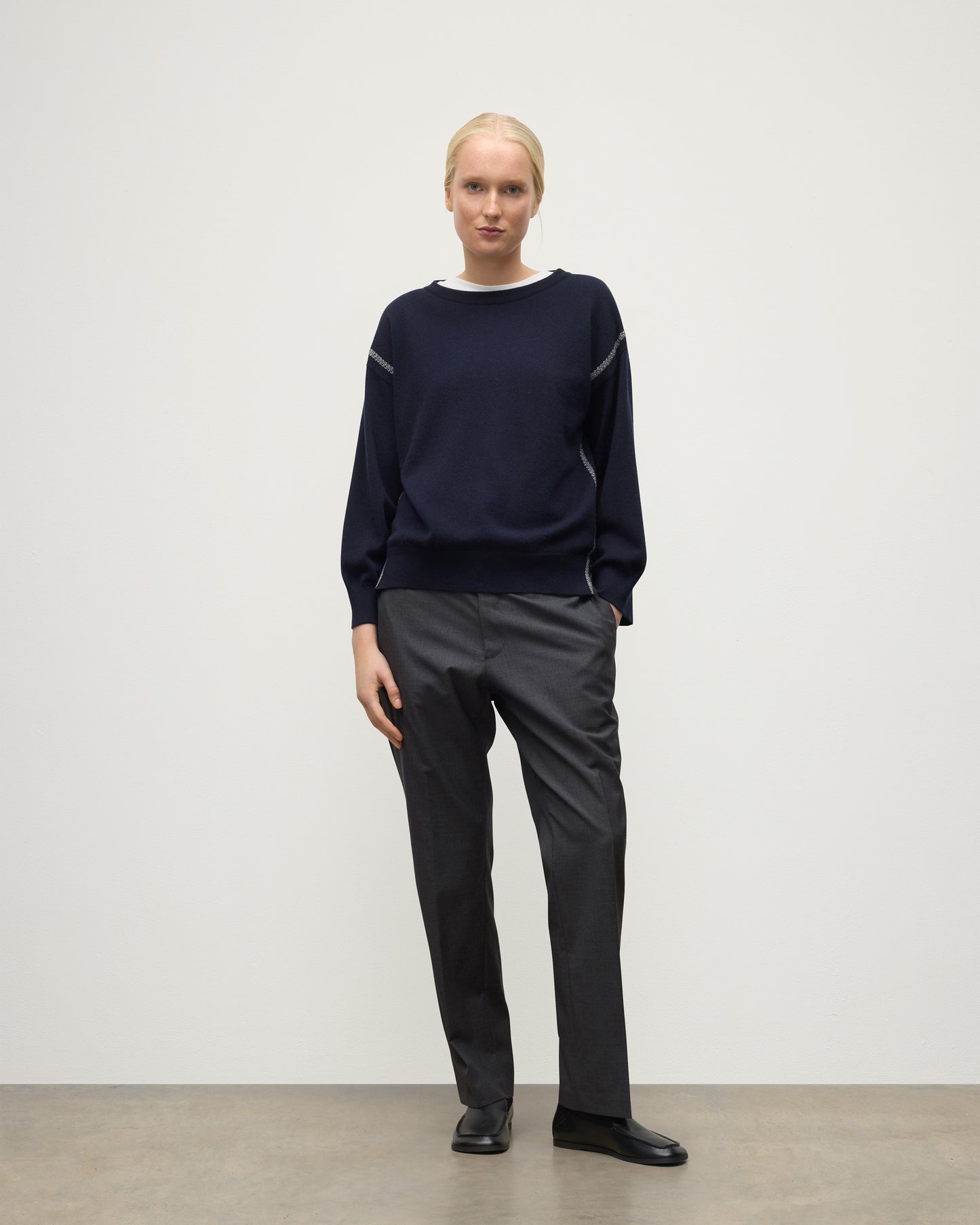 MODEL WEARING JOHNSTONS OF ELGIN WOMENS TILDA CREW SWEATER NAVY WITH GREY TROUSERS KAP05768Q25971