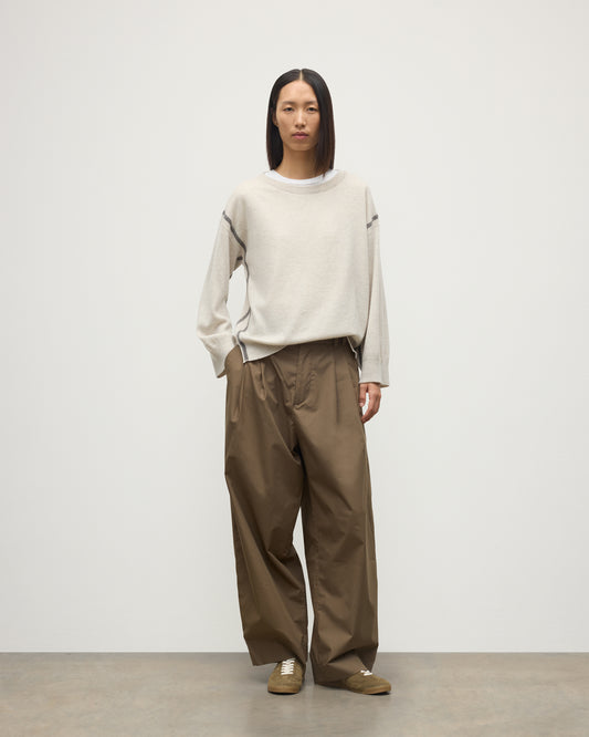 MODEL WEARS JOHNSTONS OF ELGIN WOMENS TILDA CREW SWEATER NATURAL OVER A WHITE T-SHIRT, WITH BROWN TROUSERS KAP05768Q25972