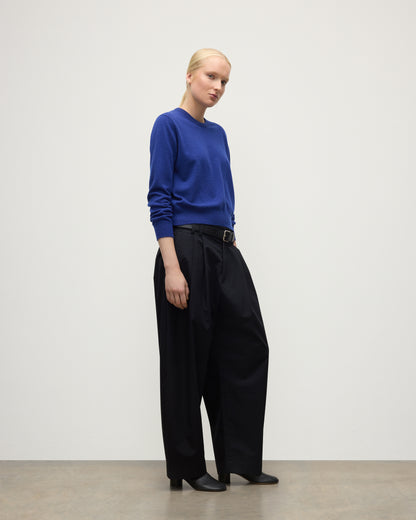 MODEL WEARS JOHNSTONS OF ELGIN WOMENS LUNAN CLASSIC CREW SWEATER BLUE  WITH BLACK TROUSERS KAP05784SD5326