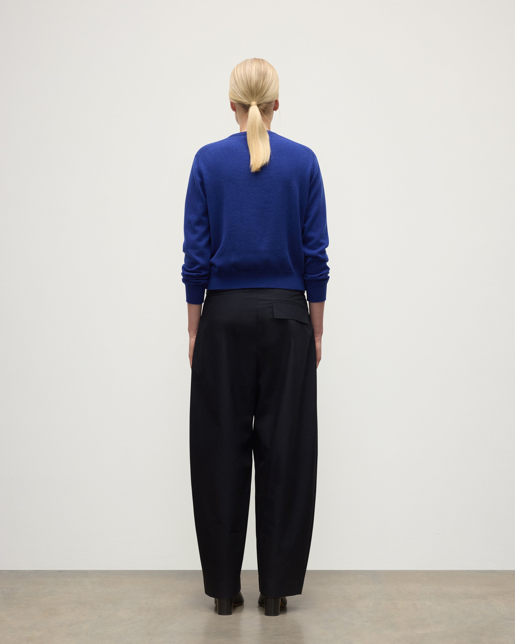 MODEL WEARS JOHNSTONS OF ELGIN WOMENS LUNAN CLASSIC CREW SWEATER BLUE  WITH BLACK TROUSERS KAP05784SD5326