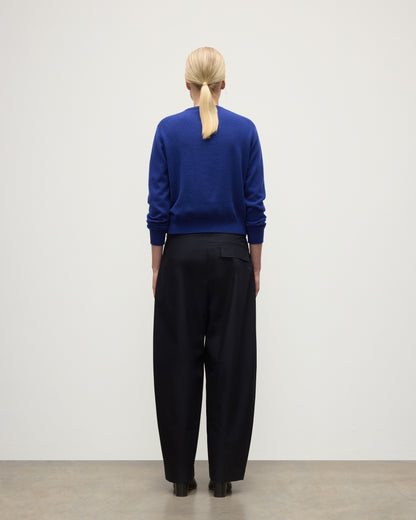 MODEL WEARS JOHNSTONS OF ELGIN WOMENS LUNAN CLASSIC CREW SWEATER BLUE  WITH BLACK TROUSERS KAP05784SD5326