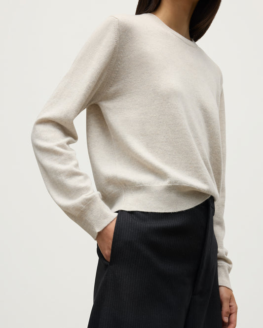 MODEL WEARS JOHNSTONS OF ELGIN WOMENS LUNAN CLASSIC CREW SWEATER NATURAL WITH BLACK WDE LEG TROUSERS KAP05784HA0402