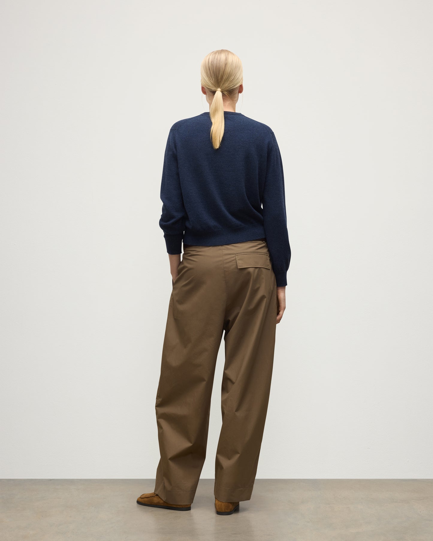 MODEL WEARS JOHNSTONS OF ELGIN WOMENS LUNAN CLASSIC CREW SWEATER NAVY WITH BROWN WIDE LEG TROUSERS KAP05784HD7350