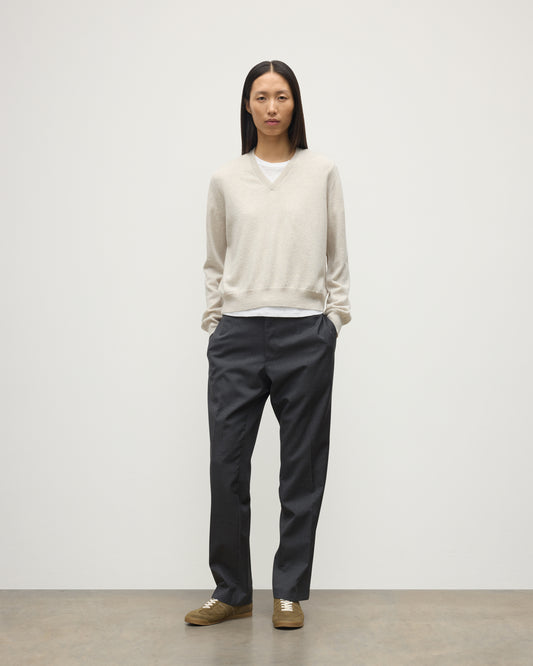 MODEL WEARING JOHNSTONS OF ELGIN WOMENS LUNAN CLASSIC VEE SWEATER NATURAL 100% CASHMERE WITH NAVY TROUSERS KAP05807HA0402