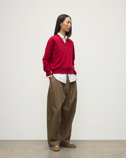 MODEL WEARING JOHNSTONS OF ELGIN WOMENS LUNAN CLASSIC VEE SWEATER RED 100% CASHMERE OVER WHITE SHIRT WITH BROWN TROUSERS KAP05807SE5325