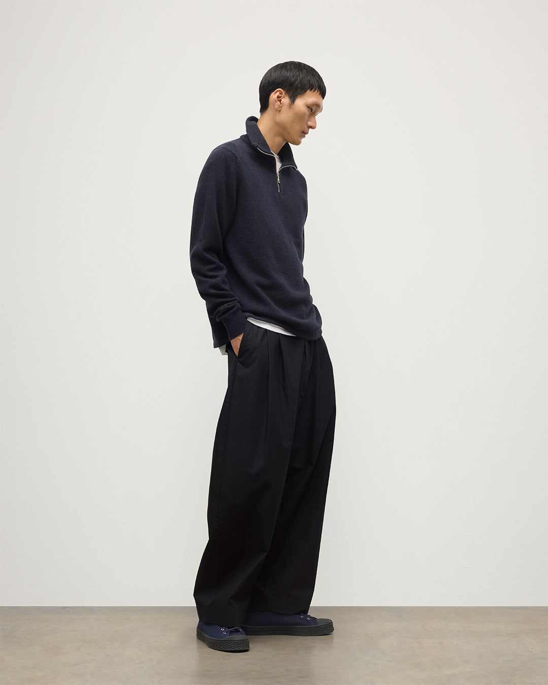 MODEL WEARS JOHNSTONS OF ELGIN MENS TWEEL HALF ZIP SWEATER NAVY & DARK GREY 100% CASHMERE OVER A WHITE T-SHIRT WITH NAVY TROUSERS KAP05832Q25934