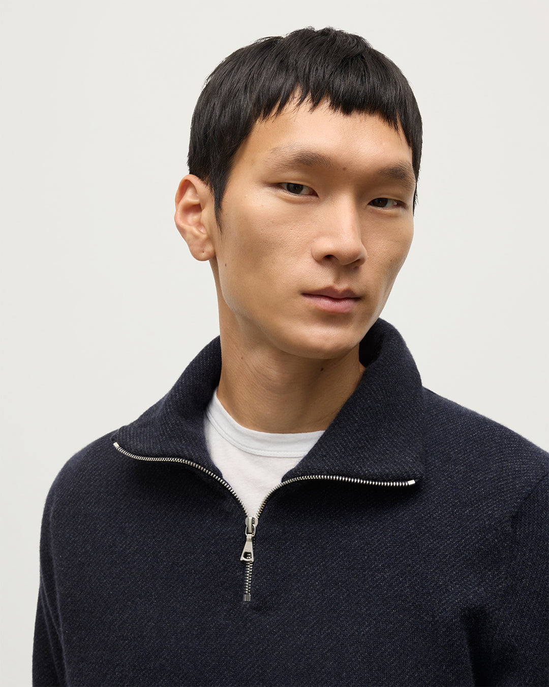 MODEL WEARS JOHNSTONS OF ELGIN MENS TWEEL HALF ZIP SWEATER NAVY & DARK GREY 100% CASHMERE OVER A WHITE T-SHIRT KAP05832Q25934