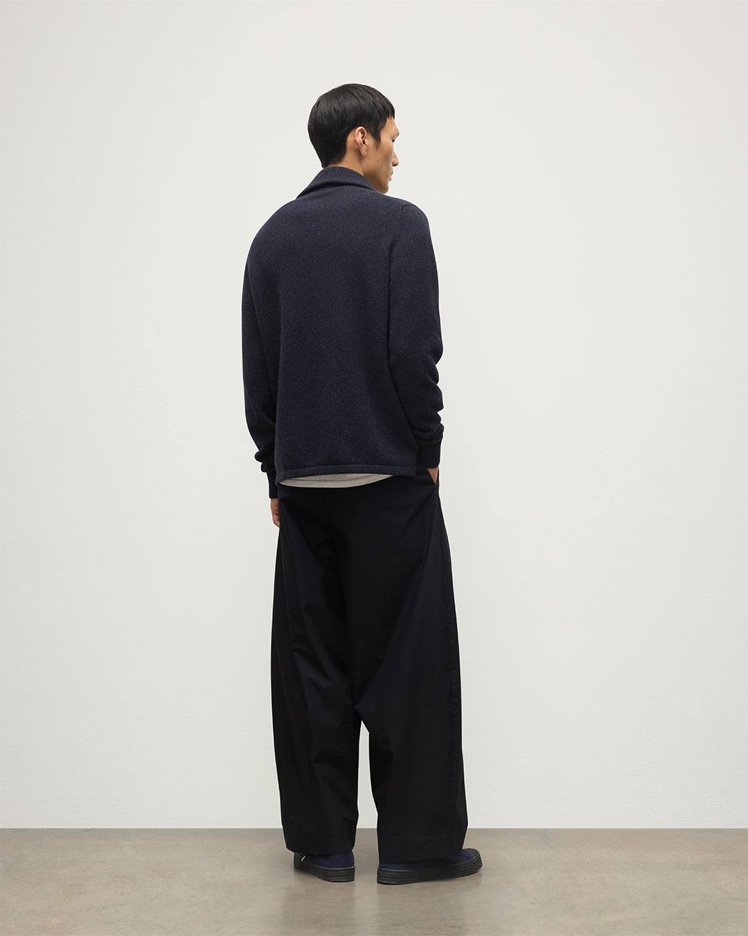 MODEL WEARS JOHNSTONS OF ELGIN MENS TWEEL HALF ZIP SWEATER NAVY & DARK GREY 100% CASHMERE OVER A WHITE T-SHIRT WITH NAVY TROUSERS KAP05832Q25934