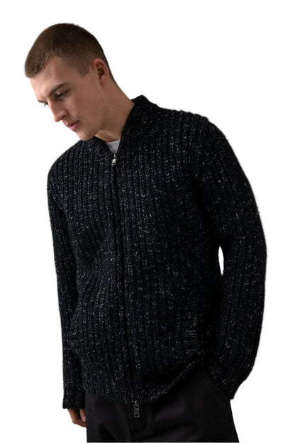 Johnstons of Elgin’s Men's Cashmere Blend Ribbed Baseball Cardigan in Black on model wearing black trousers on a grey background KBB00934Q23636