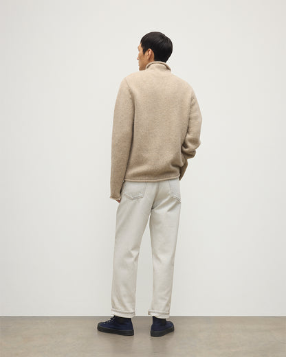 MALE MODEL WEARING JOHNSTOS OF ELGIN KESTER FUNNEL NECK SWEATER NATURAL 100% CASHMERE WITH WHITE JEANS KBB01067HB4453