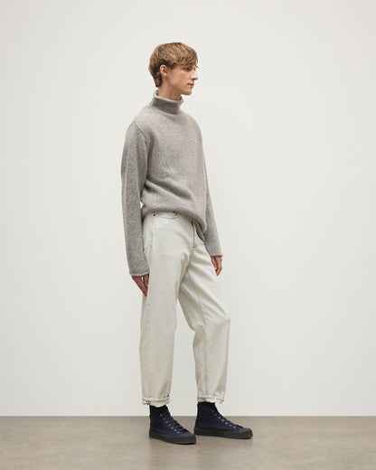 MALE MODEL WEARING JOHNSTONS OF ELGIN KESTER FUNNEL NECK SWEATER BLUE 100% CASHMERE WITH WHITE JEANS KBB01067HB4453