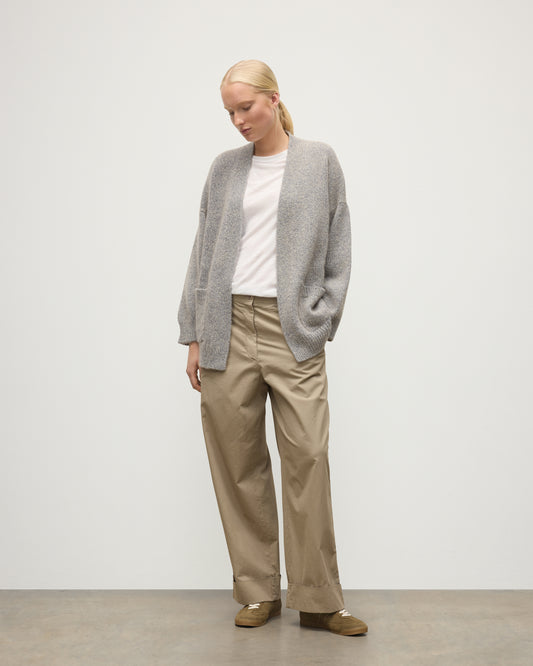 MODEL WEARS JOHNSTONS OF ELGIN WOMENS BAY SLOUCH CARDIGAN BLUE 78% CASHMERE 22% COTTON OVER A WHITE T-SHIRT WITH BROWN TROUSERS KBB01069HD4499