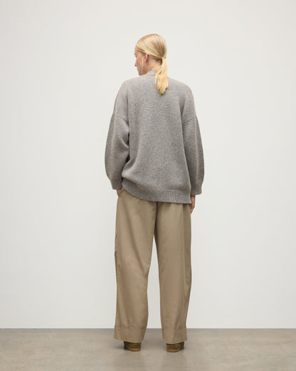 MODEL WEARS JOHNSTONS OF ELGIN WOMENS BAY SLOUCH CARDIGAN BLUE 78% CASHMERE 22% COTTON OVER A WHITE T-SHIRT WITH BROWN TROUSERS KBB01069HD4499