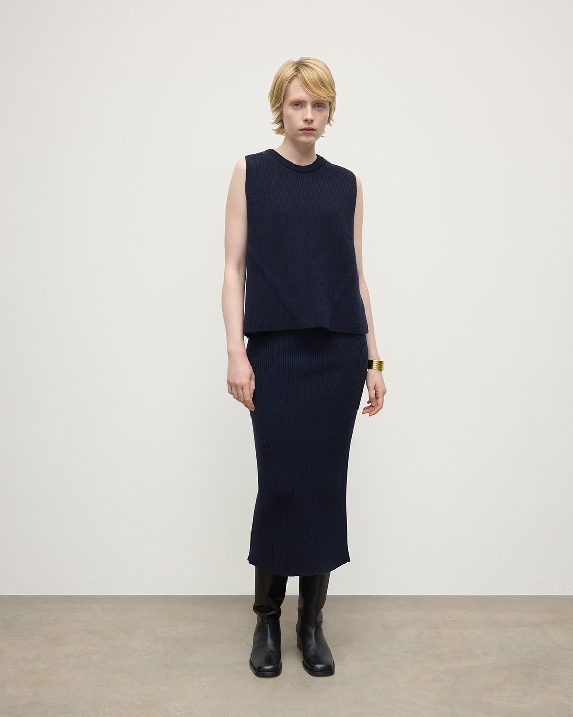 Model wears Johnstons of Elgin Women's Cashmere Midi Skirt in Navy KBC01032SD7666