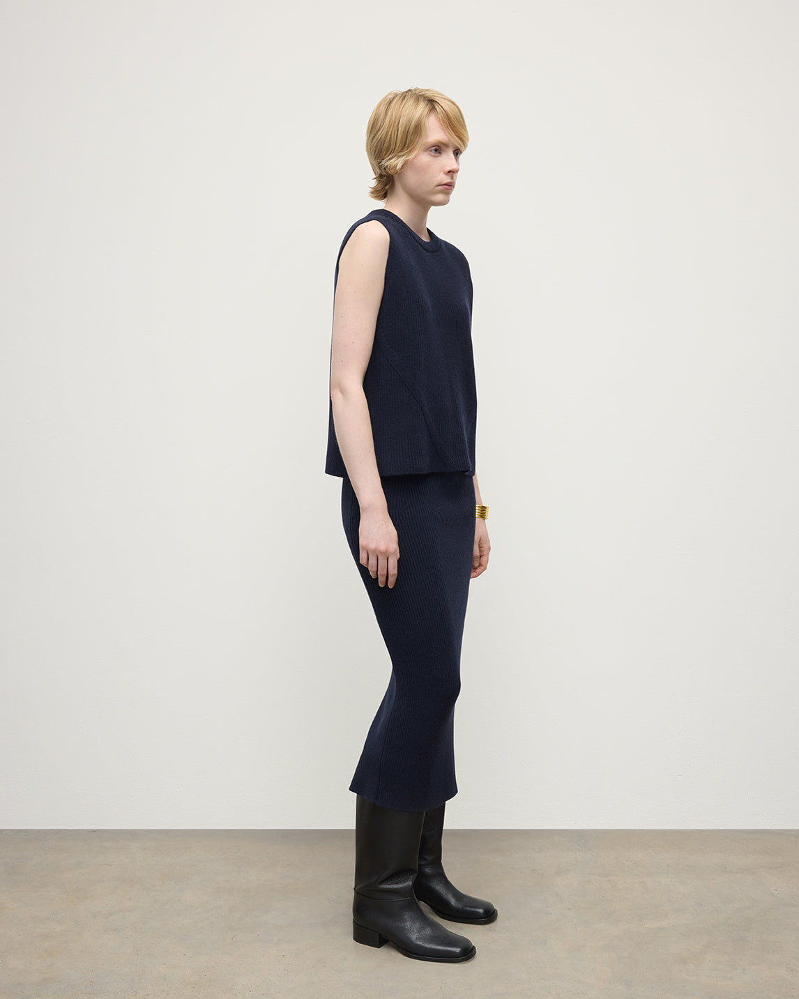 Model wears Johnstons of Elgin Women's Cashmere Midi Skirt in Navy KBC01032SD7666