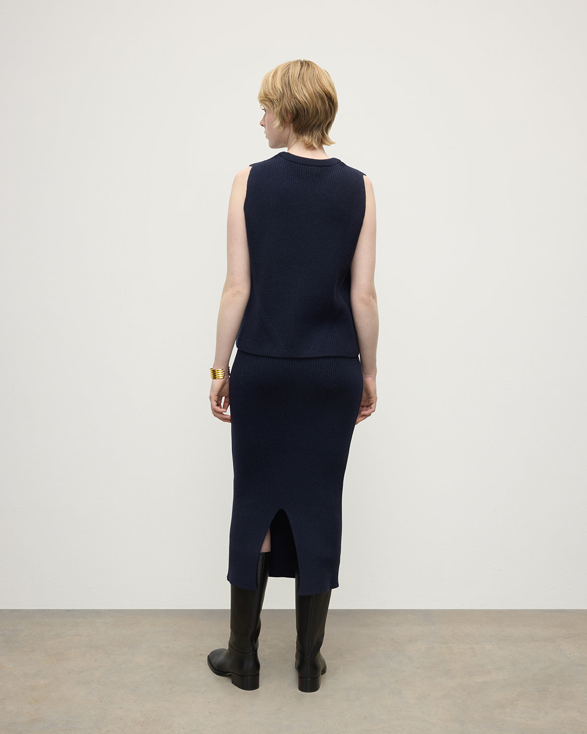Model wears Johnstons of Elgin Women's Cashmere Midi Skirt in Navy KBC01032SD7666