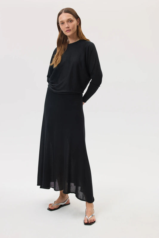 Model wearing Johnstons of Elgin SS25 Women's Knitwear Black Cashmere Silk A-Line Skirt with matching cashmere silk batwing jumper  KBI00976SA0900