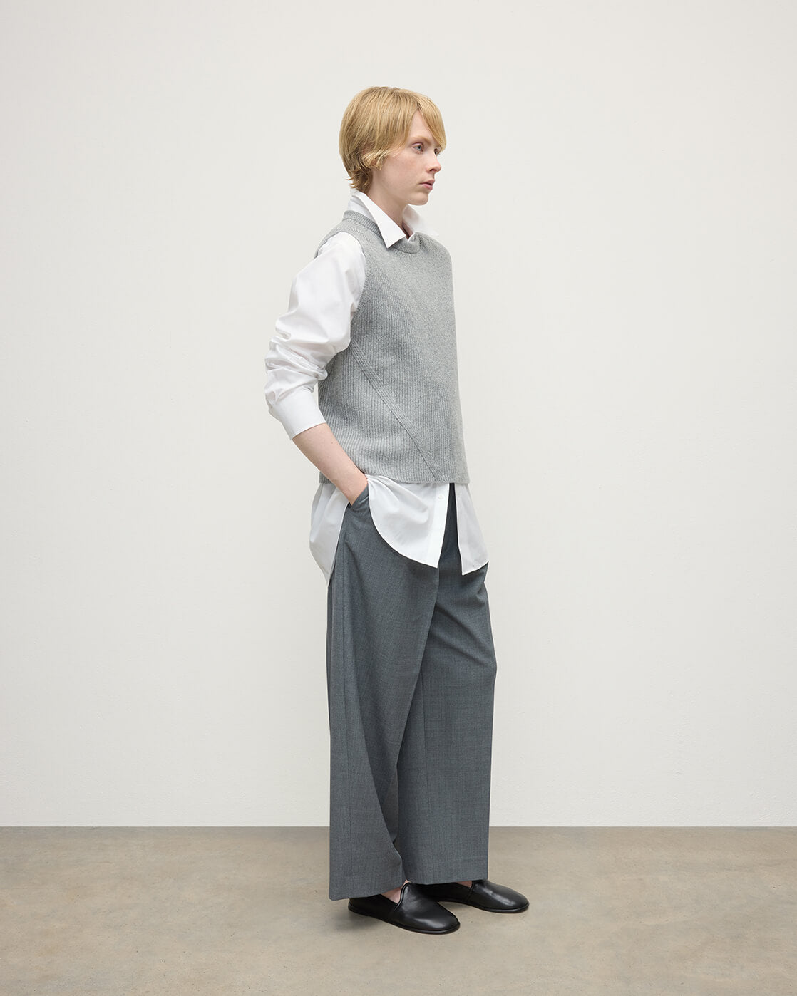 Model wearing Johnstons of Elgin AW25 Women's Knitwear Light Grey Sleeveless Grey Cashmere Tank Top Side KBI01037HA0308