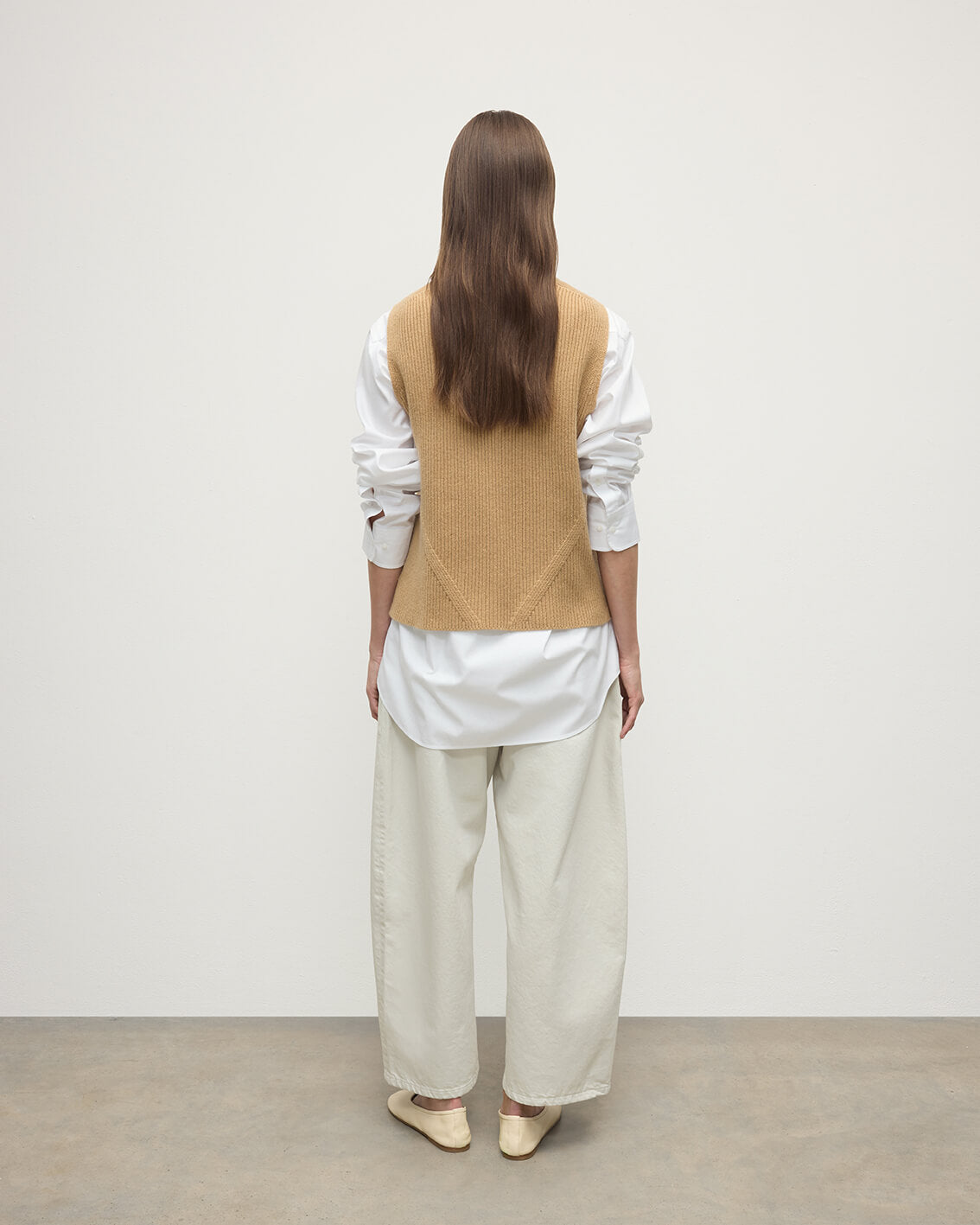 model wearing Johnstons of Elgin AW25 Women's Knitwear Camel Sleeveless Camel Cashmere Tank Top Back KBI01037HB4404