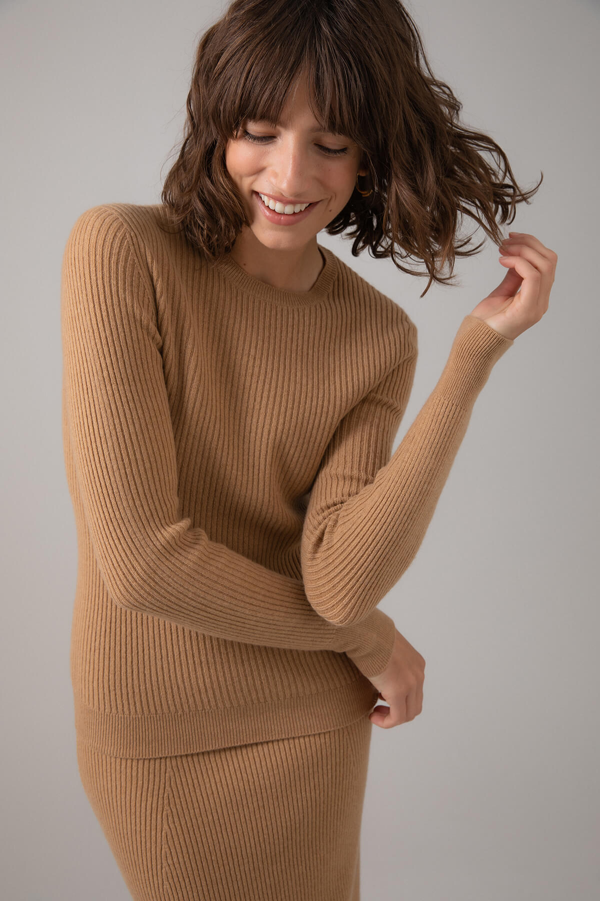 Johnstons of Elgin Women's Skinny Rib Cashmere Sweater in Camel on a grey background KBI00928HB4315